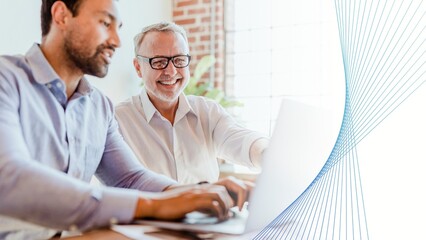 Cheerful web developers working on a laptop