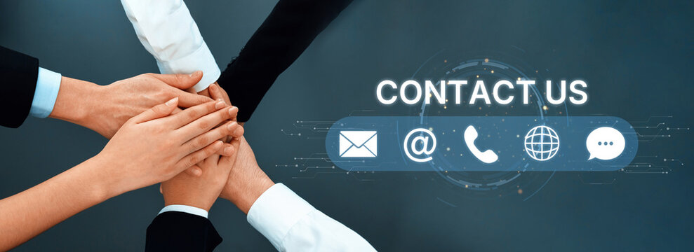 Hands of diverse individuals come together in a gesture of teamwork, emphasizing the importance of communication and collaboration in a business environment. Trope