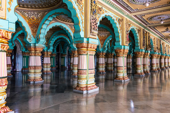 Colorful intricate architecture with pillars and arches of Royal Palace of Mysore Maharaja, Karnataka, India.