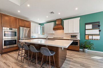 A modern kitchen with stainless steel appliances and wooden cabinets