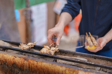 Garlic chicken wing barbecue at Hirosaki Cherry Blossom Festival, traveling in Hirosaki castle park, Aomori, Tohoku, Japan. Landmark famous in Japan. Travel and Vacation destination