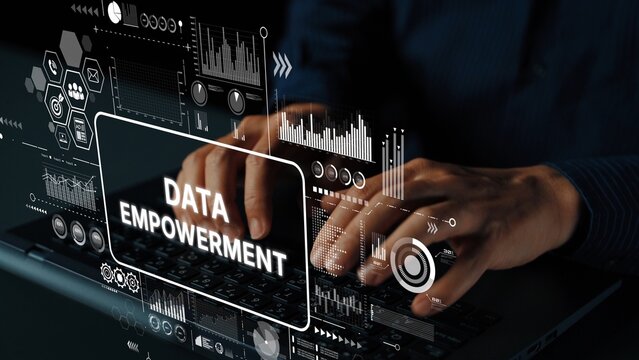 Hands typing on laptop with graphic overlay displaying data empowerment and analytics in a modern business environment. Asymptotic smart data analytic. - Powered by Adobe