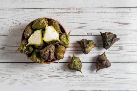 Water chestnut is a crunchy aquatic vegetable with sweet mild flavor, rich in fiber, antioxidants, vitamins, gluten-free, often used in snacks and curries.
