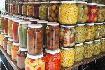 Colorful jars of pickled vegetables at a local market