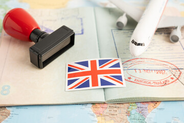 Approved Stamp  passport with United Kingdom flag document to immigration at airport in country.