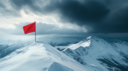 Red flag on snowy mountain peak under cloudy sky.