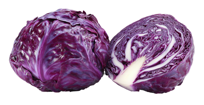 Vibrant red cabbage, whole and halved, on a black background