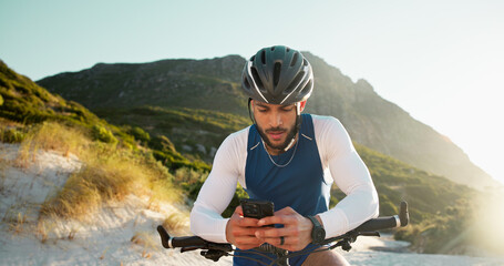 Fitness, cycling and man with phone in nature for networking, chatting or connectivity with training. Sports, cyclist and athlete with cellphone for texting, communication or contact on mobile app.