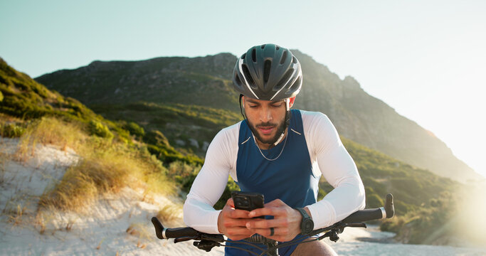 Fitness, cycling and man with phone in nature for networking, chatting or connectivity with training. Sports, cyclist and athlete with cellphone for texting, communication or contact on mobile app.
