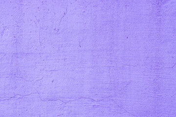 A close-up photo of an old, painted concrete wall.