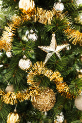 christmas tree with gold and silver decorations including stars and tinsel