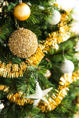 christmas tree with gold and silver decorations including stars and tinsel