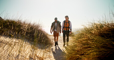 Hiking, friends or men on trail with support, connection or motivation for exploration goals. Adventure, backpack or people outdoor with walk, endurance or bonding together for trekking milestone.