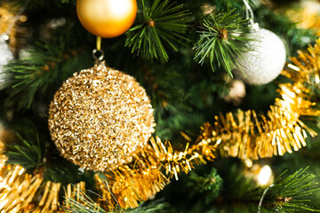 christmas tree with gold and silver decorations including stars and tinsel