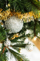 christmas tree with gold and silver decorations including stars and tinsel