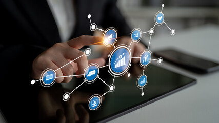 A business professional interacts with a digital tablet, showcasing icons that symbolize data analytics, market growth, and technological innovation in the finance sector. Tessel