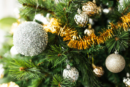 christmas tree with gold and silver decorations including stars and tinsel