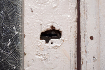 The keyhole on the old painted door