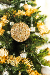 christmas tree with gold and silver decorations including stars and tinsel