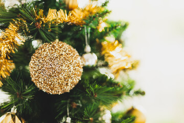 christmas tree with gold and silver decorations including stars and tinsel