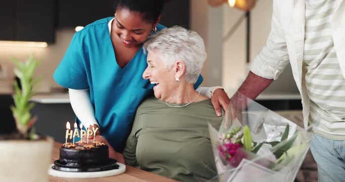 Senior woman, birthday and cake with bouquet at house for party, celebration and surprise. Elderly couple, flowers and gift with nurse for special occasion, sweet treat and romantic kiss of milestone