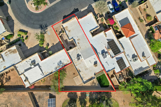 Aerial view of a residential area with a red line for building