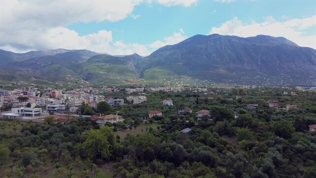Aerial establishing shot , raise up, revealing Taugetus mountain from olive trees orchards on a cloudy autumn day 4k. Kalamata, Peloponnese , Messinia, Greece.