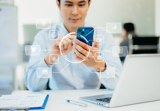 Digital marketing media in virtual screen.businesswoman hand working with mobile phone and modern compute with VR icon diagram at office in morning light - Powered by Adobe