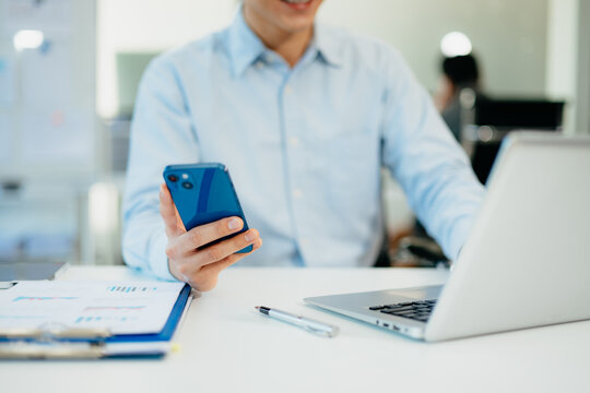 businessman working with digital tablet computer and smart phone with financial business strategy layer effect on desk in morning light - Powered by Adobe