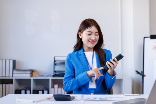 Young businesswoman using smartphone working in modern office