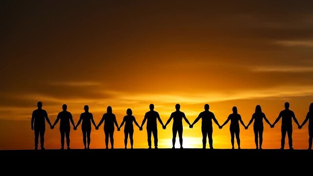 Silhouetted figures stand hand-in-hand against an orange and golden sunset, forming a line, showing unity
