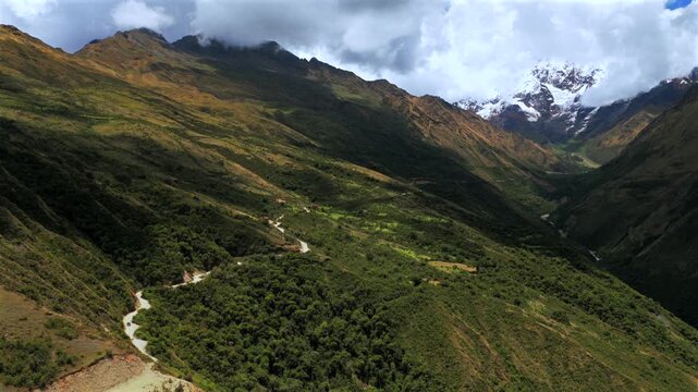Soray dirt road Mount Humantay Laguna Lake Sulcantay Trek Peruvian Andes Mountain Range Peru Per&uacute; aerial drone clouds blue skies high altitude elevation snow capped glacial peaks forward motion