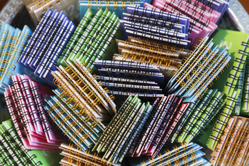 Vibrant, colorful pile of metallic candy wrappers creates fun abstract background. sweet collection...