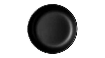 Overhead view of a black non-stick frying pan against a black background