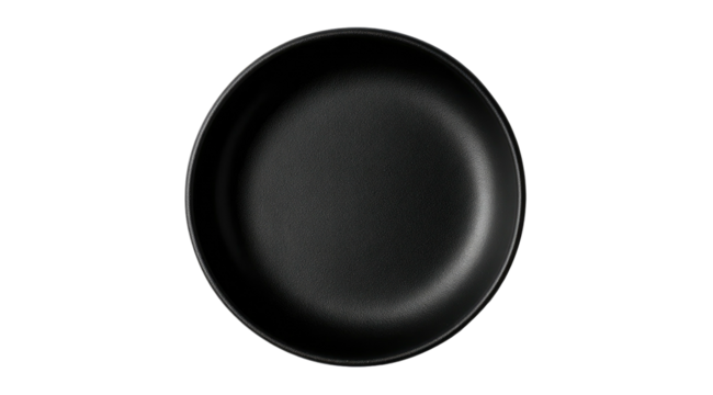 Overhead view of a black non-stick frying pan against a black background