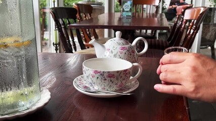 Preparing hot tea with honey syrup, pouring steaming tea from a kettle into a cup, capturing the warm, cozy 4K video footage - Powered by Adobe