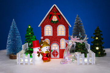 In the foreground of a large house with orange lights in the windows, surrounded by a fence, there...