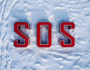 SOS distress signal on snow, a universal signal used to call for help.