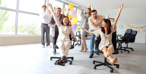 Group of business people having fun at birthday party in office