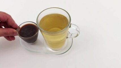 Dark coffee and light tea sit side by side in clear cups, highlighting rich contrast and tactile clarity, a simple yet striking balance of warmth and brightness in every sip