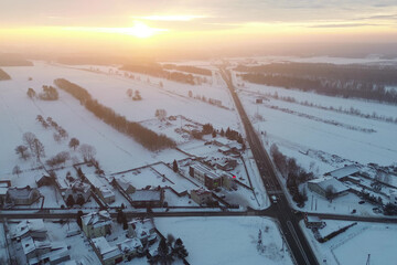 Sunrise Over Snowy Road in Winter Wilderness