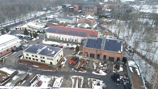 Factory parking lot and solar panels in snowy setting