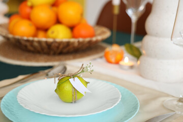 Beautiful table setting with citrus fruits. Closeup
