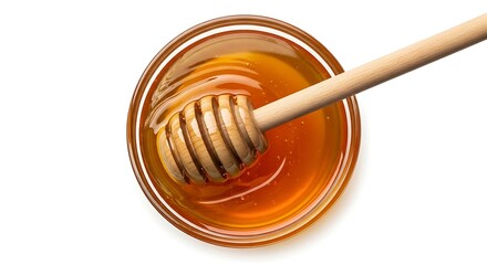 Golden honey dripping from wooden dipper into bowl