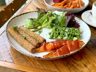 Vegan Lunch: Falafel, Sweet Potato, Avocado, Cucumber, Pesto Sauce and Salad Leaves. Plant-Based Food and Healthy Eating Concept. Handheld Phone Photo, Selective Focus, Sunlight, No A