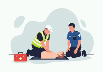 A responder in a yellow safety vest performs chest compressions on a training mannequin while a uniformed colleague kneels nearby next to a red first aid kit on the floor © Skyframe