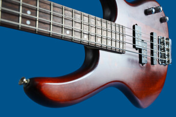 Obraz premium Modern electric guitar on dark blue background, closeup