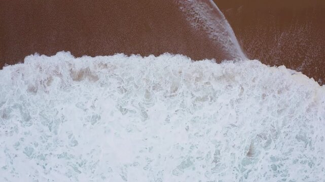 Atlantic ocean waves washing sandy coast at Farol da Nazar&eacute; in Nazare, 4K aerial beautyful natural background video