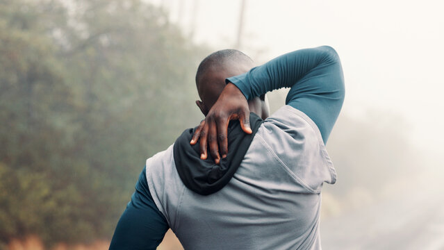 Back, fitness and stretching with man on mountain trail for start of cardio or training routine. Exercise, warm up and workout with athlete person outdoor in overcast forest for health or wellness