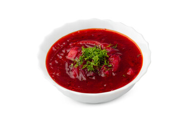 Delicious beet soup garnished with fresh herbs served in a white bowl